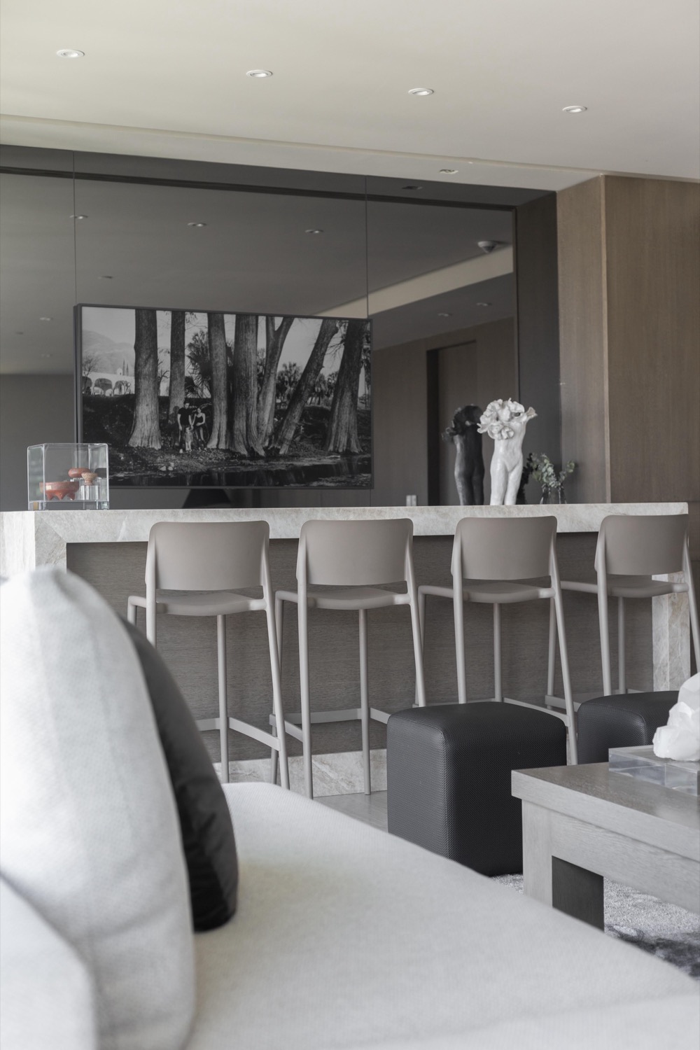 Cassea — marble bar counter with stools and mirrored wall