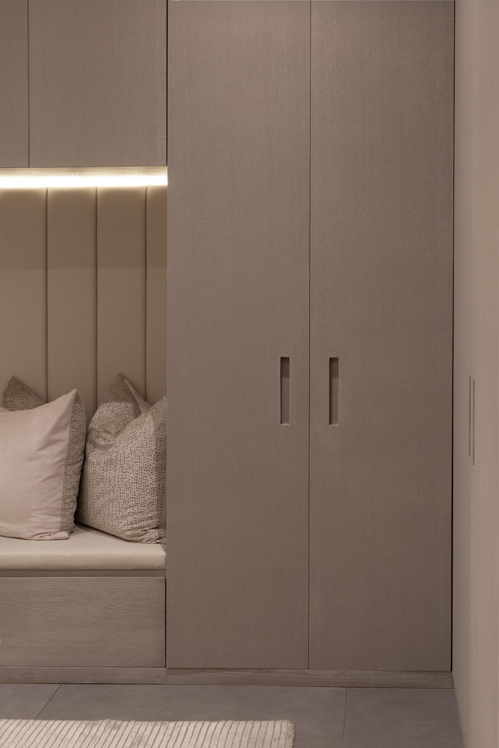 Magnolia — upholstered bench nook with concealed lighting and joinery